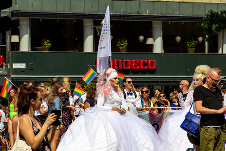 MalmÃ¶, Sweden - July 20, 2019: A drag queen dressed in a white wedding dress takes part in the pride parade through the city center of MalmÃ¶, Sweden.のeditorial素材