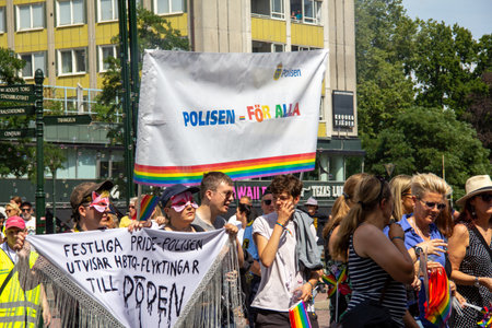 MalmÃ¶, Sweden - July 20, 2019: Contradicting messages (Police is for everyone vs. pride police kicks out lgtb refugees) during the annual pride parade of downtown MalmÃ¶, Sweden.のeditorial素材