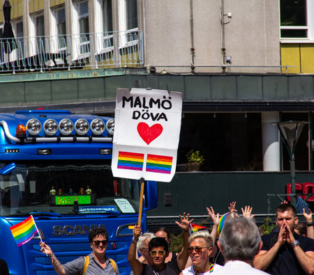 MalmÃ¶, Sweden - July 20, 2019: A woman is holding a sign representing the deaf lgtb people in MalmÃ¶ during the 2019 pride parade.のeditorial素材