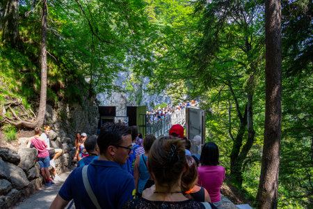 Neuschwanstein, Germany - July 20, 2018: Crowds of people fills the viewpoint bridge MarienbrÃ¼cke that displays Neuschwanstein Castle from its best sideのeditorial素材