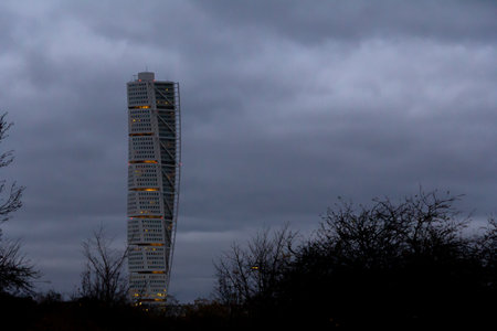 MalmÃ¶, Sweden - November 18, 2018: Skyscraper Turning Torso rises above MalmÃ¶ during a cold autumn evening.のeditorial素材