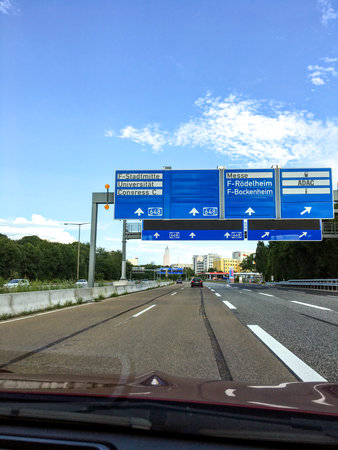 Frankfurt am Main, Germany - July 20, 2017: Big signs over the highway as the car enters the city of Frankfurt with skyscrapers in the distanceのeditorial素材
