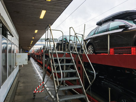 Hamburg, Germany - July 16, 2017: Cars are loaded on to the train while passengers are waiting to go on the car train (Autozug) through Germanyのeditorial素材