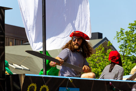 Lund, Sweden - May 19, 2018: A young man student is dressed as a pirate while showing at a float in a paradeのeditorial素材