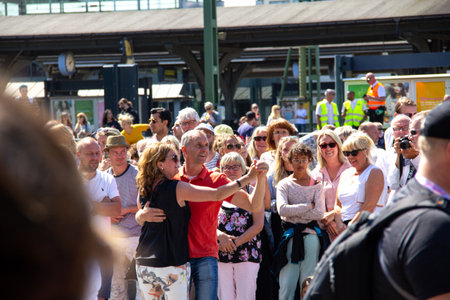 Lund, Sweden - May 19, 2018: A couple started a spontaous dance on the street as the Lundakarnevalen parade passes byのeditorial素材
