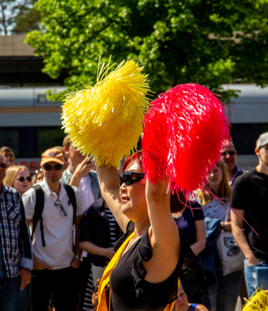 Lund, Sweden - May 19, 2018: An asian woman is enjoying herself and dancing as she participates in a student paradeのeditorial素材