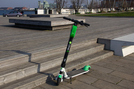 MalmÃ¶, Sweden - April 6, 2019: An electric scooter from the brand Lime is parked in the harbour area on a warm spring dayのeditorial素材