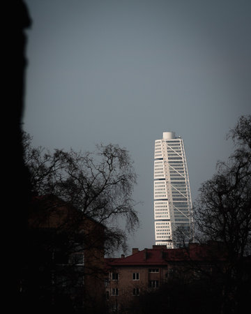 MalmÃ¶, Sweden - April 7, 2019: Skyscraper Turning Torso is rising above the older buildings from the '40s and '50sのeditorial素材