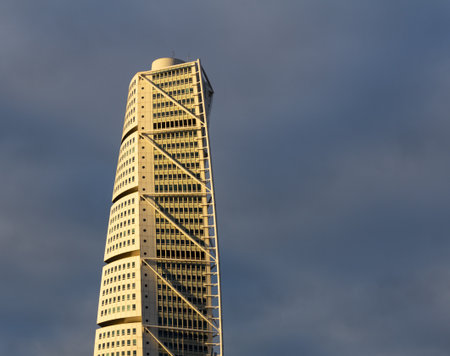 MalmÃ¶, Sweden - November 25, 2018: The top part of skyscraper Turning Torso is visible in the winter sun as the sun sets on this cold dayのeditorial素材