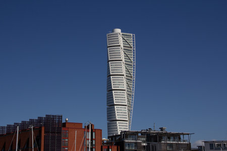 MalmÃ¶, Sweden - May 11, 2019: Turning Torso, a white twisted skyscraper, is visible high above the other buildings in the cityのeditorial素材