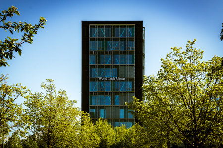 MalmÃ¶, Sweden - May 11, 2019: One of the high rise buildings that makes up World Trade Center is visible above the spring trees in the downtown areaのeditorial素材