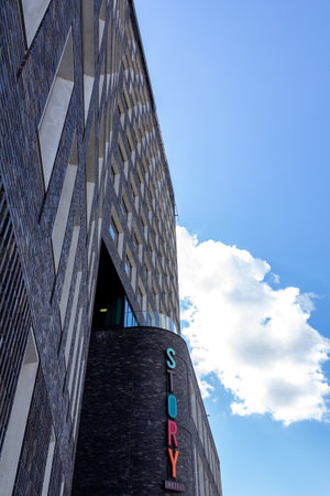 MalmÃ¶, Sweden - July 11, 2018: The facade of Story Hotel rising towards the clear blue sky with fluffy cloads on a bright summer day. Has copy space.のeditorial素材