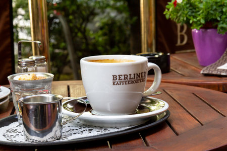 Berlin, Germany - June 1, 2019: A nice blank white cup of coffee on a metal tray gives a calm feeling in the cafÃ© Berliner KafferÃ¶sterei on a bright summer day.のeditorial素材