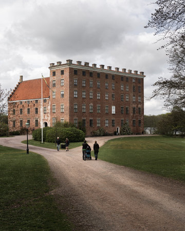 Svaneholm, Sweden - May 1, 2020: A family is walking towards the castle on an overcast spring dayのeditorial素材