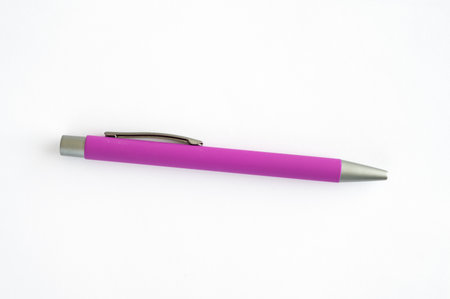Pink pen placed isolated on white surfaceの写真素材