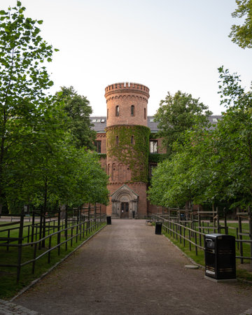 View through park towards medieval building Kungshuset (Kings house) in Lund, Swedenのeditorial素材
