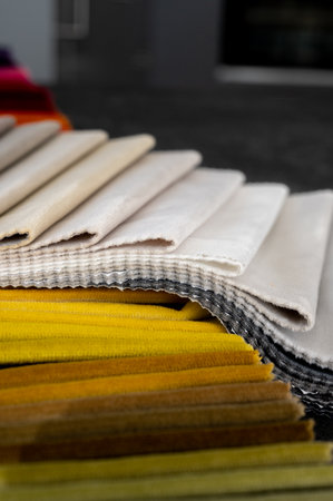 Folds of velvet samples in autumn or fall color tones placed on a stone tableの写真素材