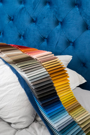 Luxury velvet samples in gradient colors placed on a pillow in a bed for the customers to select fromの写真素材
