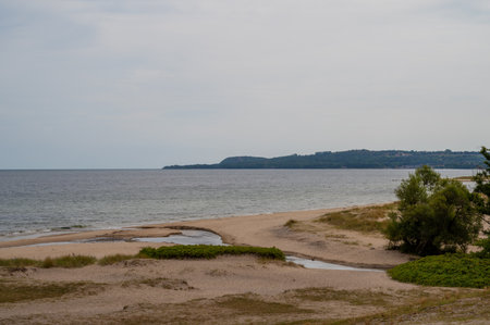 The beach of HavÃ¤ng is empty and in the distance the mountain and national park Stenshuvud is visible on the horizonの写真素材