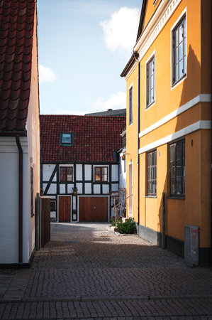 Cobblestoned alley with old crooked half-timbered houses in Lund Swedenの写真素材