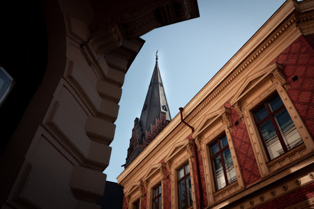 Church tower visible high above old historic facades in the city centre of MalmÃ¶ Sweden in summerのeditorial素材