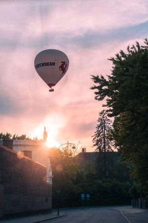 A hot air balloon decorated with the newspaper Sydsvenskan logo during sunset in Lund Swedenのeditorial素材
