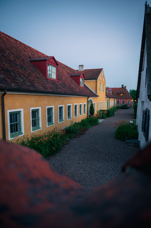 Old buildings and plants in idyllic village setting in Lund Sweden during summer eveningの写真素材