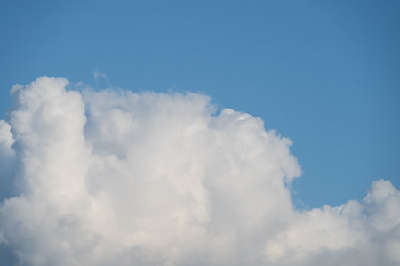 Fluffy white cloud close-up with blue skyの写真素材