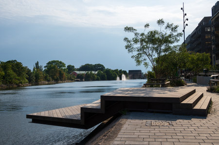 A modern boardwalk along the canal with fountains in MalmÃ¶ Sweden during summerの写真素材