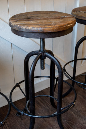 Rustic bar stool against white wallの写真素材