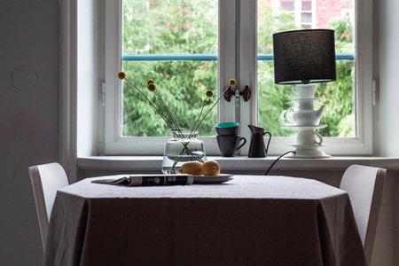 Modern cottage kitchen interior with table in front of windowの写真素材