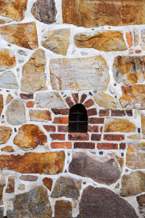 Old historic jail stone facade with bricks textureの写真素材