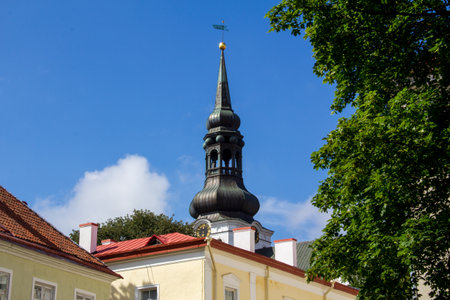 The steeple with a clock of a church in Tallinn Estonia during summerの写真素材