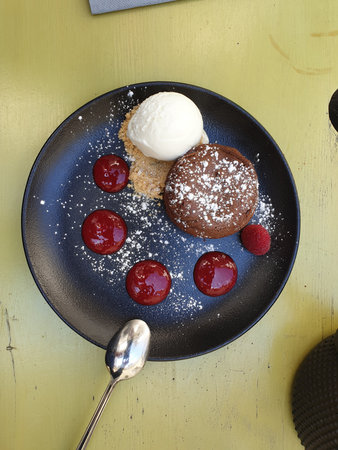 Top down view of a plate of chocolate cake dessert with ice cream and jam in rustic settingの写真素材