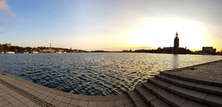 Panoramic view of the water and the city hall of Stockholm Sweden during summer sunsetの写真素材