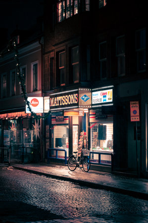 Lund, Sweden - December 10, 2021: The historic photo store called Mattsons in downtown Lund during rainy nightのeditorial素材