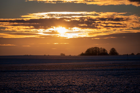 Cloudy winter sunset above rural farm fields in SkÃ¥ne Swedenの写真素材