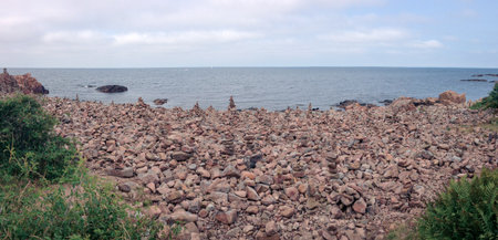 Rocky stone beach at Hovs hallar in SkÃ¥ne Sweden with lots of stacked stonesの写真素材