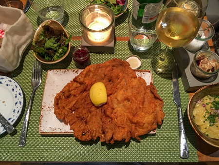 Traditional Austrian schnitzel dinner at fullt tableの写真素材