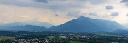Dramatic sky over mountains surrounding Salzburg Austria in summer timeの写真素材