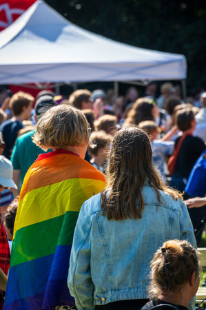 Woman wearing a rainbow colored pride flag on a local pride festival in Lund Swedenの写真素材