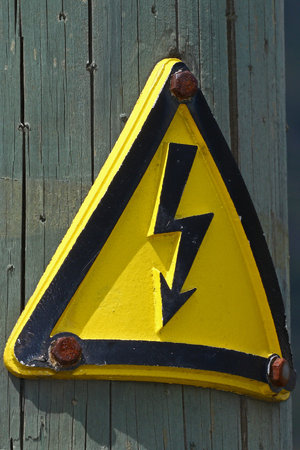 Old high voltage warning signの写真素材