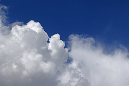 Cumulus nimbus thunderstorm clouds against blue skies