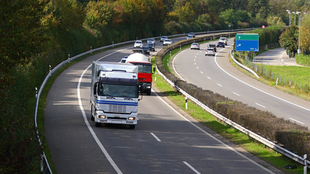 Trucks rolling in highway traffic from above and with blank road direction signsのeditorial素材