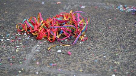 Colorful carnival leftovers on the ground backgroundの写真素材