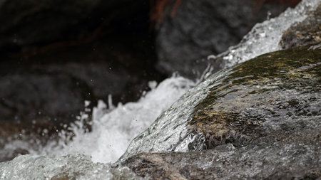 Water flowing through granite rocks in mountain rapids