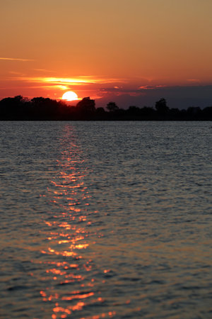 Colorful sunset over the Adriatic laguna between Grado and Veniceの写真素材