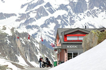 Nufenen Pass, Val Bedretto, Ticino, Switzerland,June 8,2017: Two bikers at the lodge on top of reopened snow-covered Novena pass in Val Bedretto,Ticino, in the springtimeのeditorial素材