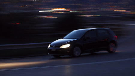 Black car racing at night motion blur