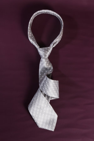 grey tie on purple leather backgroundの写真素材